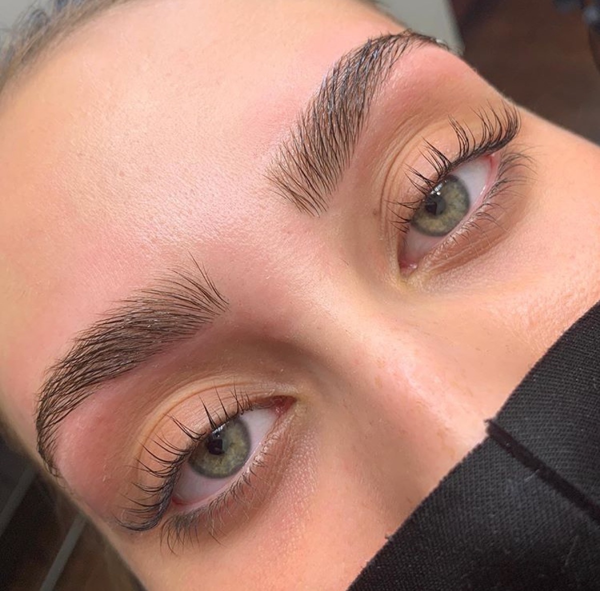 Brow lamination close-up showing lifted brow hairs