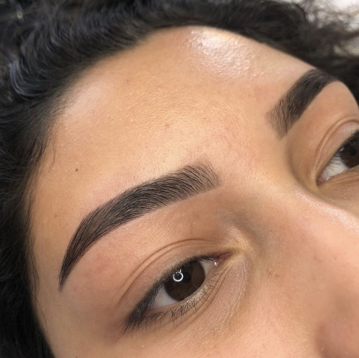 Eyebrow threading result showing clean defined brows